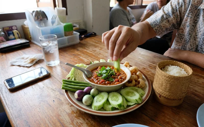 Nam prik ong with fresh vegetables and sticky rice